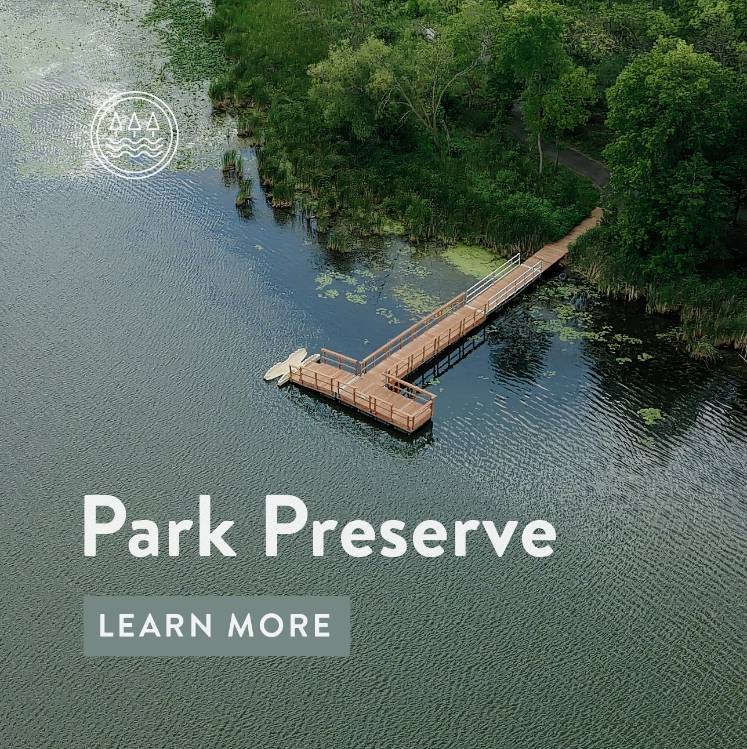An aerial image of a fishing pier extending into the lake with text 'Park Preserve Learn More'